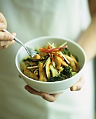 Chicken and vegetable stir-fry with noodles (with fork)