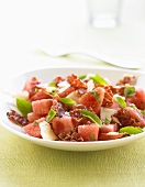 Watermelon salad with fried bacon and Parmesan