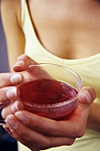 Young woman holding a cup of rose hip tea