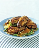 Chicken wings on pan-fried vegetables