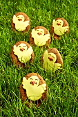 Egg-shaped Easter biscuits with chick decoration in grass