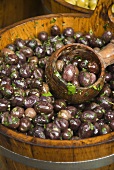 Pickled olives in wooden tub at a market