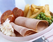 Ham with chips, peas and tomatoes