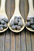 Allspice on three wooden spoons