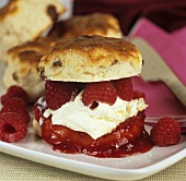 Scones with raspberry jam, clotted cream and raspberries