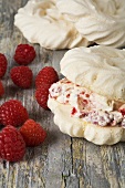 Meringues filled with cream and raspberries