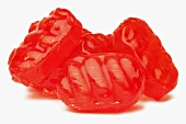 Several red sweets (without wrappers)