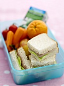 Sandwiches, fruit and vegetables in a lunch box
