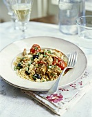 Lamb fillet with tomatoes, black olives and couscous