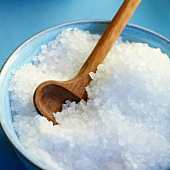 Rock salt and wooden spoon in a dish