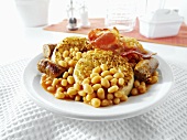 English breakfast: crumpets, sausages, bacon, baked beans
