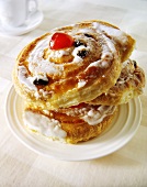 Three raisin danishes on a plate