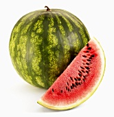 A whole watermelon and a wedge of watermelon