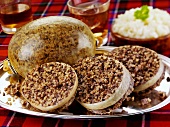Haggis (Offal, oatmeal etc. cooked in sheep's stomach, Scotland)