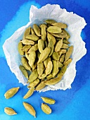 Cardamom pods on greaseproof paper