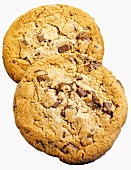 Two chocolate chip cookies on white background