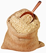 Rice in jute sack with scoop