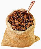Star anise in jute sack with scoop