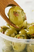 Marinated green olives with olive fork