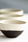 Three black and white bowls