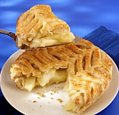Apple pie with puff pastry crust, a piece on server