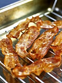 Grilled rashers of bacon on a grill rack