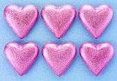 Six chocolate hearts in pink foil