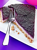 A piece of blueberry cheesecake with a biscuit base