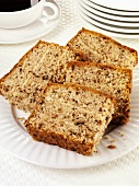 Four slices of walnut cake on a plate