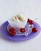 Turron ice cream in a glass bowl with cherries