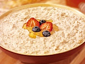 Porridge with honey, strawberry and blueberries