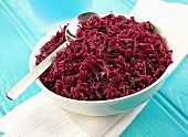 Red cabbage in dish with spoon