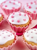 Cupcakes with white icing and pink sugar pearls