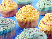 Cupcakes with yellow and blue meringue toppings