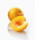 One half and one whole apricot