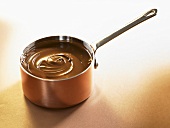 Melted chocolate in a copper pan