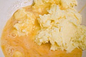 Mixing eggs with creamed butter and sugar