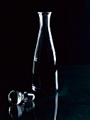 A carafe of wine against a black background