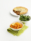 Carrots and green beans, vegetable pie in background