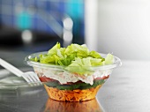 Layered salad in plastic container to take away