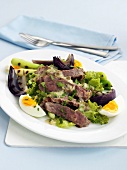 Warm beef salad with onions and egg