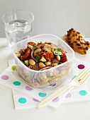Vegetable salad with beans and tuna fish in a storage box