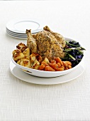 Roast chicken with roast potatoes, carrots and vegetables
