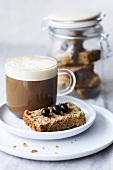 A glass cup of coffee with shortbread