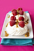 Meringues with raspberries and passion fruit sauce