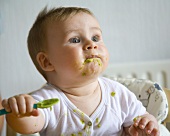 Baby eating pureed vegetables