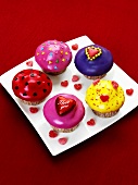 Muffins with coloured icing and hearts