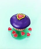 Muffin with purple icing and heart-shaped jelly sweets