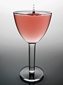 Glass of rosé wine with drop