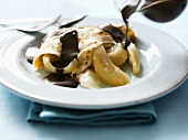 Pancake with poached pear and chocolate sauce